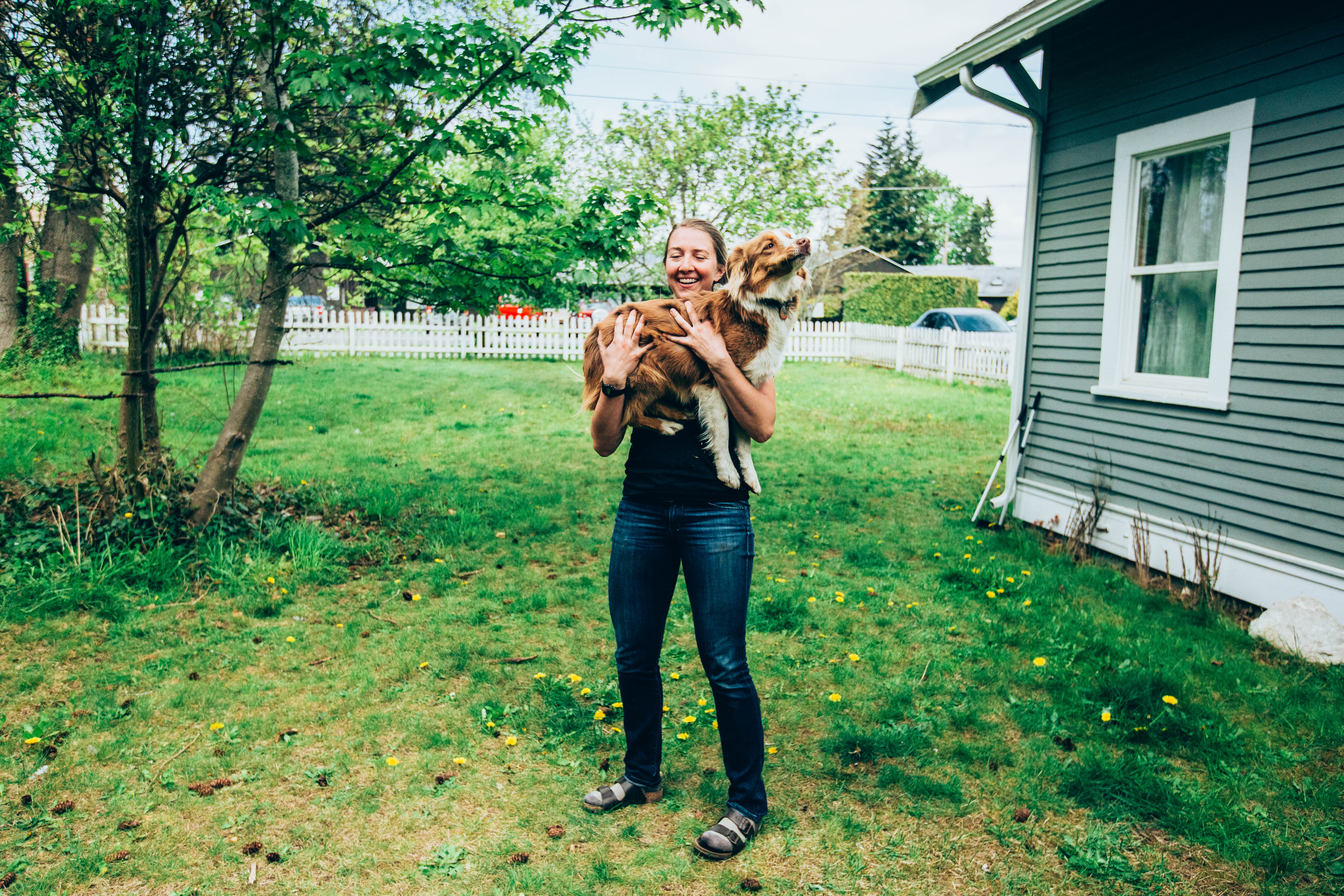 Shelly holds her roommate's dog in her yard at her house in Bellingham, Wash., on Thursday, May 2, 2019. (Photo by Regan Bervar)