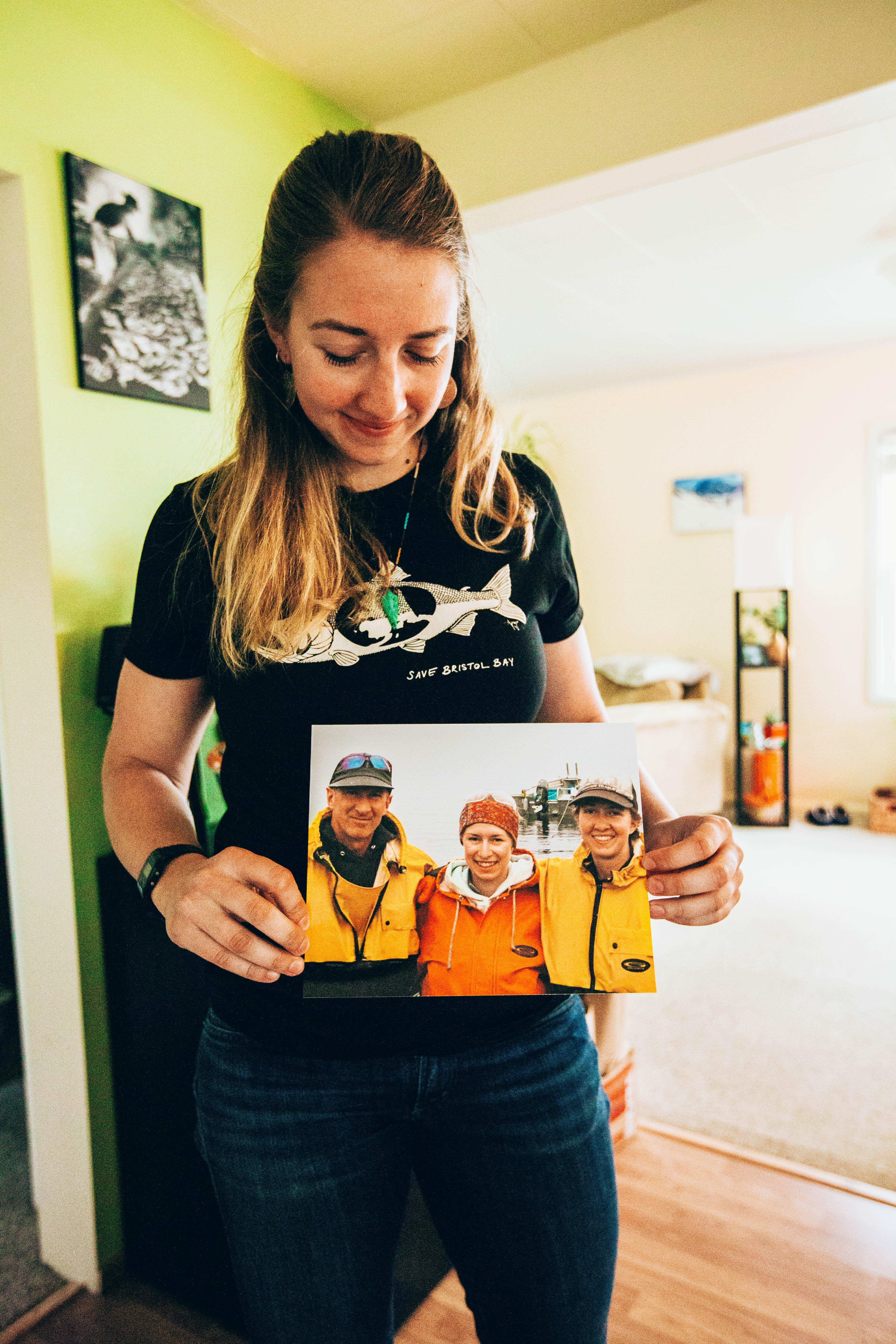 Shelly Larsen holds up a photo of her father, sister and herself in her kitchen at her home in Bellingham, Wash., on Thursday, May 2, 2019. (Photo by Regan Bervar)